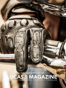 Motorcycle accident scene with gloved hand and chrome detail, representing motorcycle injuries and legal options.