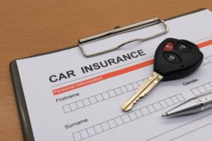 motor insurance with car key and pen