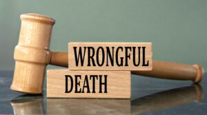 Justice spelled on wooden blocks with a gavel, symbolizing wrongful death claim after accident.